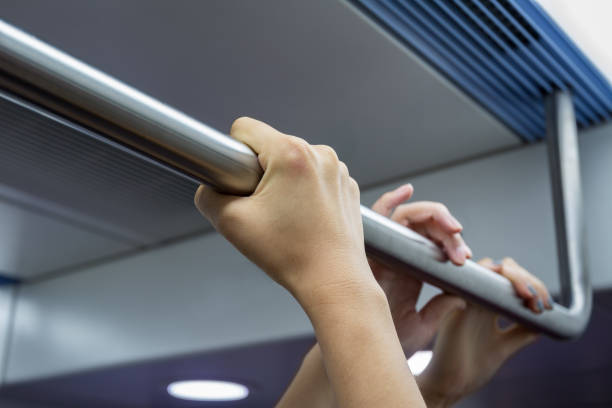 istock People holding handrail tightly on work or after work. 1295030086