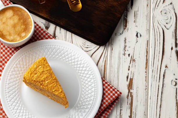 istock Slice of layered honey cake on plate 1295030227