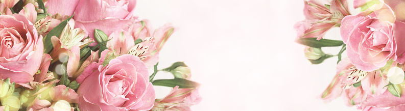 Beautiful pink rose and alstroemeria flowers in a bouquet on soft bokeh background