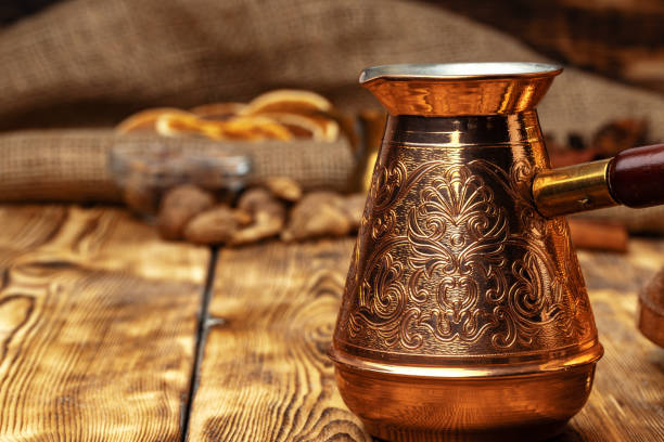 istock Shiny copper turk with brewed coffee on brown wooden table 1295031152