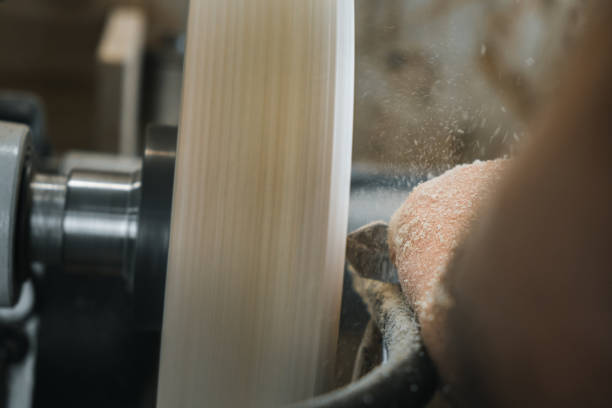 istock a man in a working apron works on a wood turning lathe. hands hold a chisel. hobby 1295032282