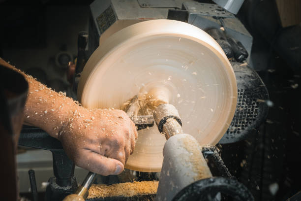 istock a man in a working apron works on a wood turning lathe. hands hold a chisel. hobby 1295032293