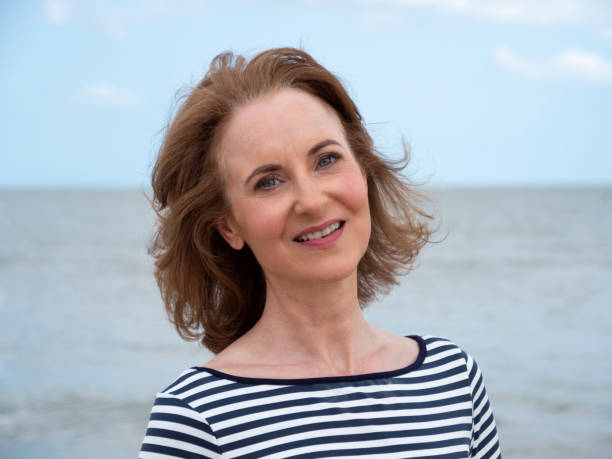 istock Smiling mature woman at beach. 1295032640