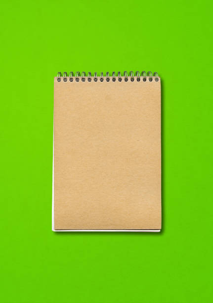 istock Spiral closed notebook mockup on green background 1295035339