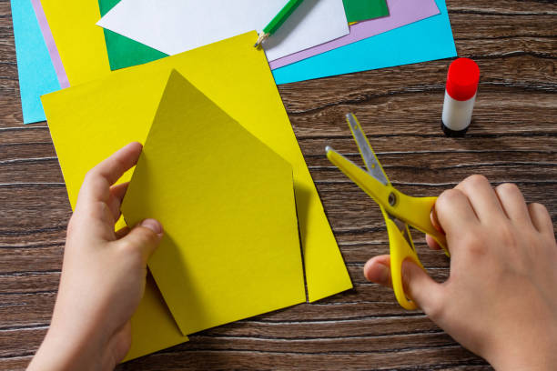 istock Instruction step 3. Spring postcard birdhouse with a bird. Handmade. Project of childrens creativity, handicrafts, crafts for kids. 1295038356