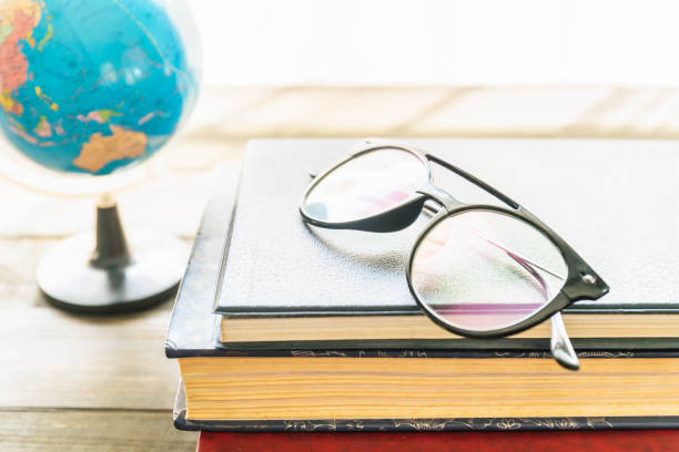 istock Reading glasses put on hardcover books 1295038654