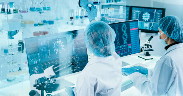 istock Young female microbiologists studying coronavirus. Futuristic lab 1295039423