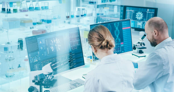 istock Young microbiologists studying coronavirus. Futuristic lab 1295039458