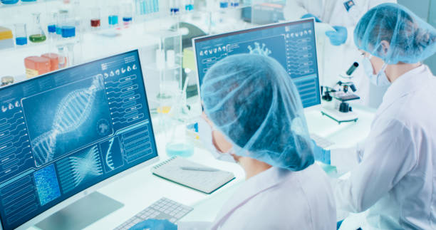 istock Young female microbiologists studying coronavirus. Futuristic lab 1295039465
