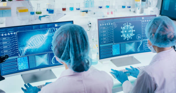 istock Young female microbiologists studying coronavirus. Futuristic lab 1295039468