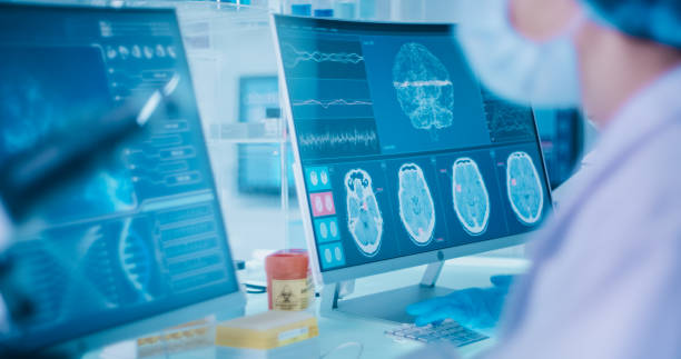 istock Female scientists studying brainwave scanning models and DNA sequencesl. 1295039470