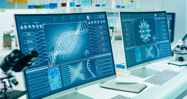 istock Futuristic laboratory equipment - coronavirus testing. DNA and virus models on screens 1295039486