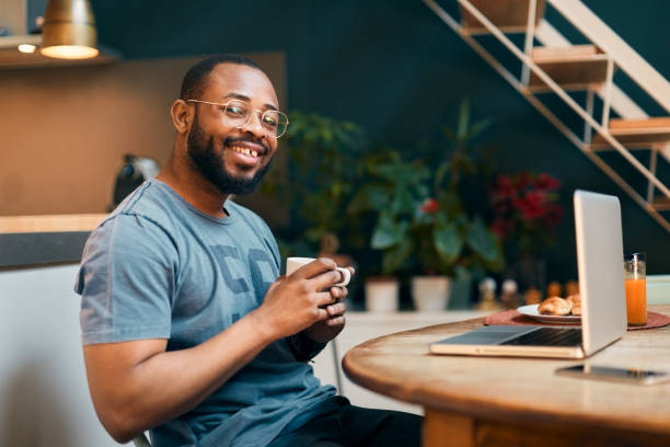 istock Man working from home with and smiling a the camera. 1295040817