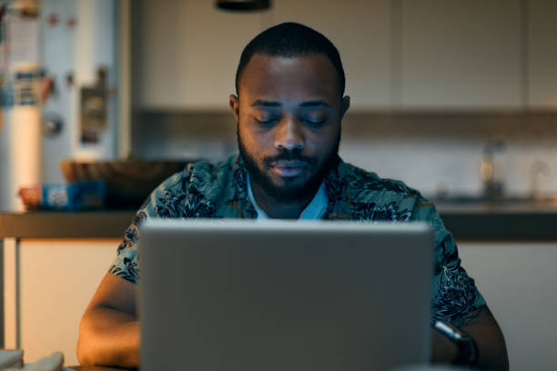 istock Front view of  one man working late at home. 1295040885