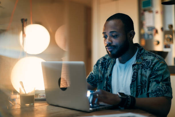 istock One man using a laptop late at home. 1295040906
