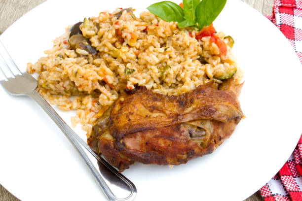 istock pieces of grilled chicken and vegetable rice 1295041985