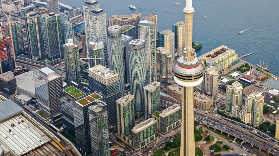 Aerial view of modern skyscrapers and CN Tower with Lake Ontario in background, Toronto, Ontario, Canada.