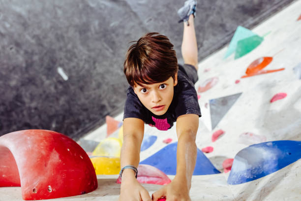 istock Young boy climbing an indoor climbing wall 1295043523