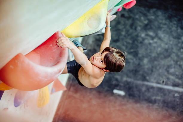 istock Young boy climbing an indoor climbing wall 1295043668