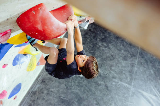 istock Young boy climbing an indoor climbing wall 1295043720