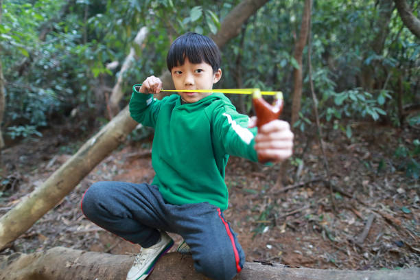 A rock is pulled back in an sling shot pointed