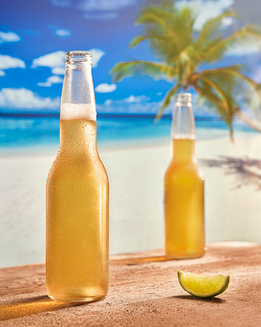 Two Beers by a tropical beach with lime