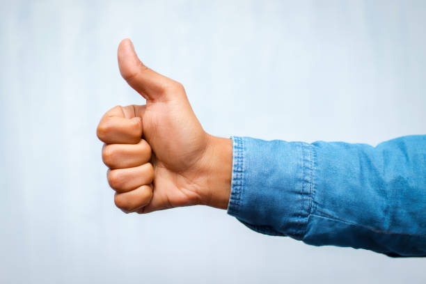 a gentleman showing his thumb.thumps up showing.like symbol. - thumps up imagens e fotografias de stock