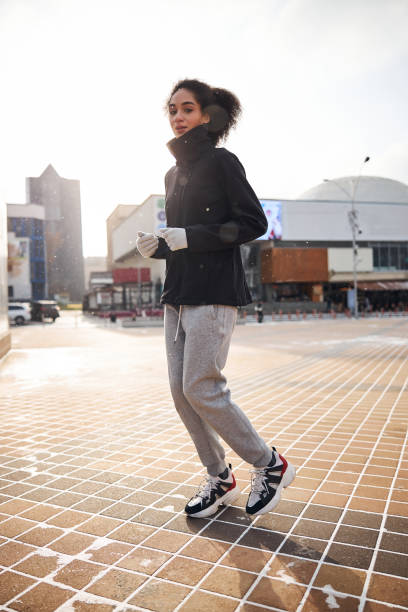 istock Bothered female jogging leisurely through the central area 1295048086