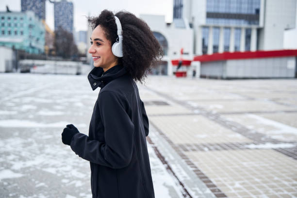istock Female runner doing some jogging at a city centre 1295048114