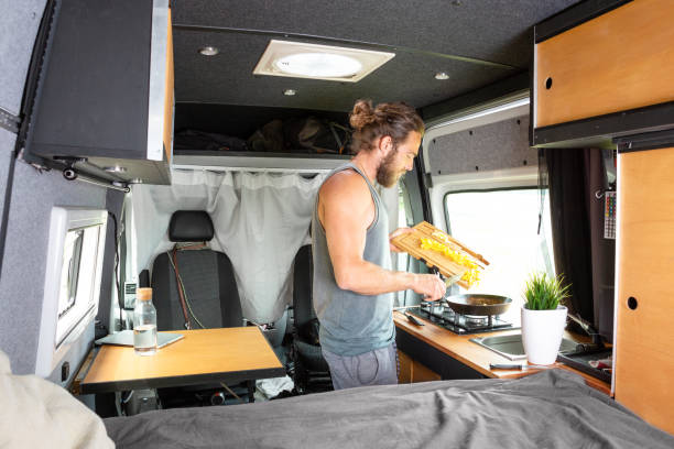 istock Man inside his camper van is preparing food 1295048446