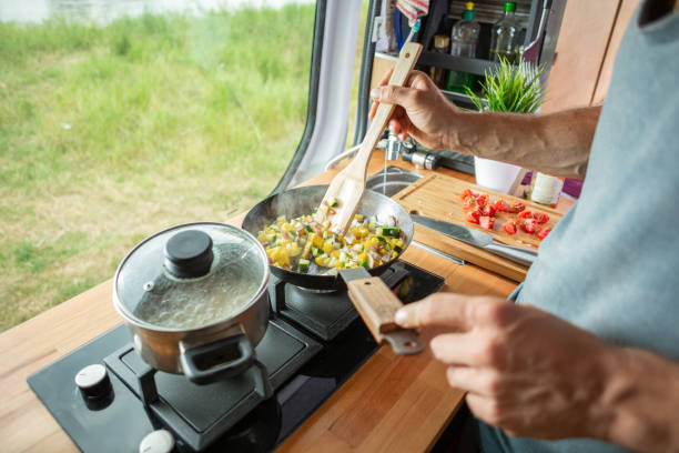 istock Cooking food on a stove inside a caravan 1295048454