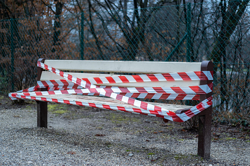 Outdoor benches covered with barricade tape