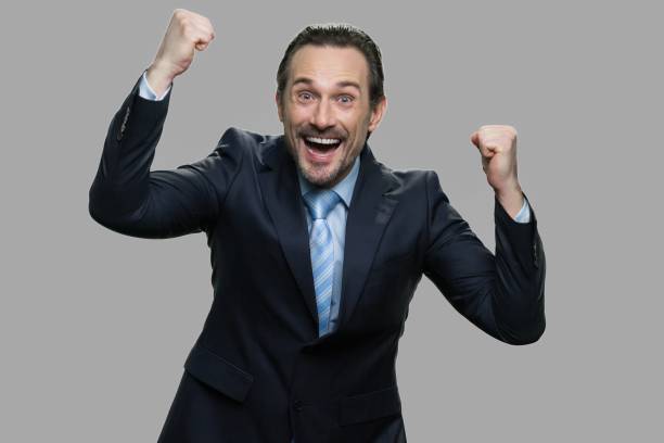 istock Lucky handsome businessman celebrating success. 1295049391