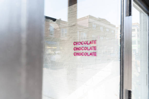 istock Sign inside coffee shop, seen through a window reflection. Sign read chocolate three times 1295050492