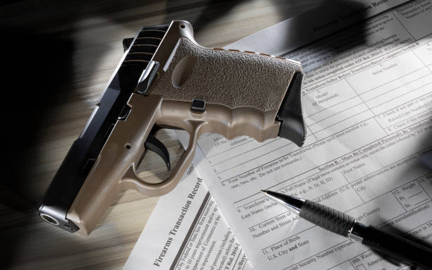 istock Federal public domain gun application form with a polymer pistol on top 1295051929
