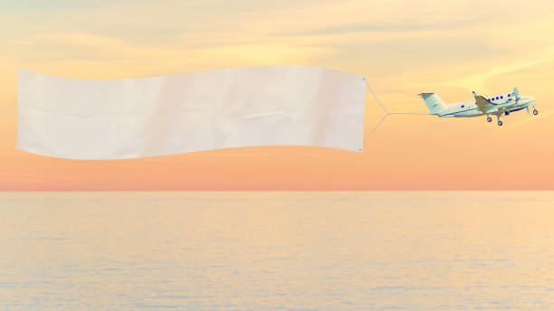 istock Plane with ad banner over sea 1295054707