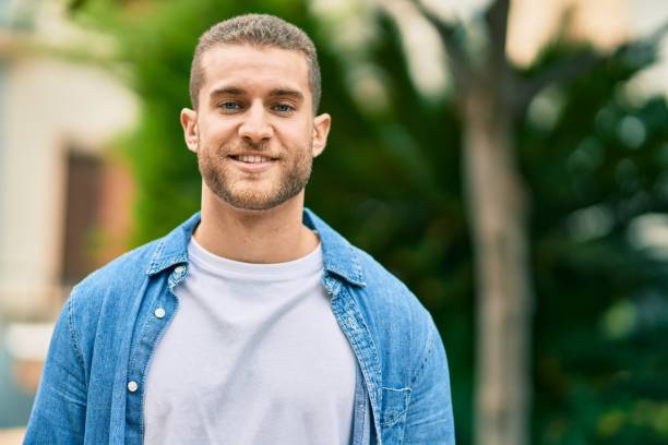 istock Young caucasian man smiling happy standing at the park. 1295054852