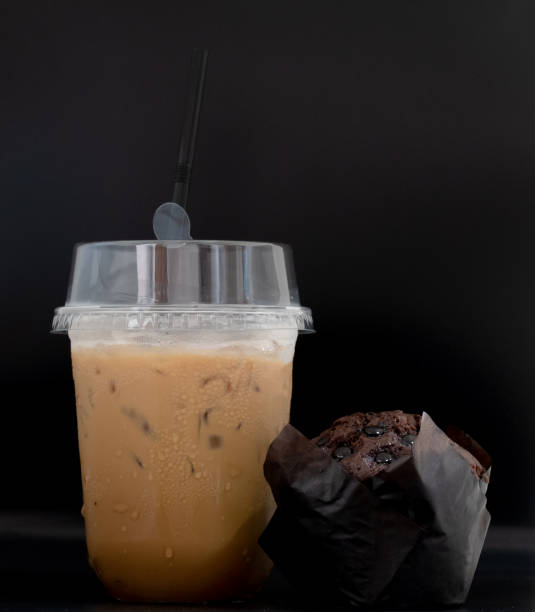 iced coffee in plastic glass with cholocate bakery and have water droplets adhering to the glass - adhering imagens e fotografias de stock