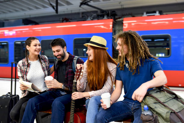 istock Few friends at the train station while waiting for a train for a long journey 1295057155