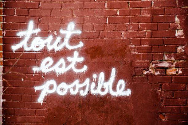 all is possible - graffiti believe wall single word imagens e fotografias de stock