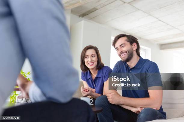 Couple Discussing Problems With Psychotherapist Stock Photo - Download Image Now - Financial Advisor, Living Room, Meeting