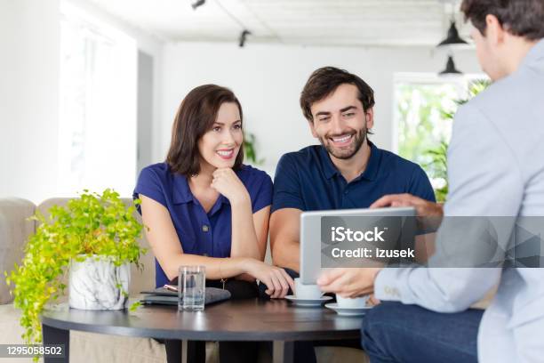 Couple Discussing With Financial Advisor Stock Photo - Download Image Now - Financial Advisor, Meeting, Couple - Relationship