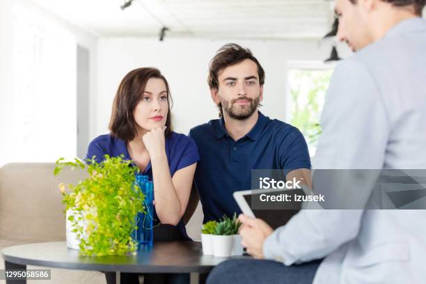 Couple Discussing With Financial Advisor Stock Photo - Download Image Now - Real Estate, Real Estate Agent, Debt