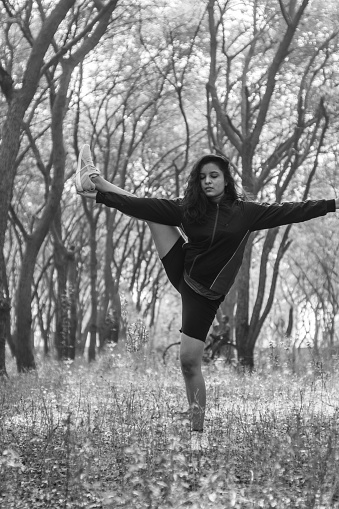 A sporty woman in sportswear practicing yoga in the nature. female happiness. beautiful young woman exercising in the nature. Caucasian female fitness model working out in the morning.
