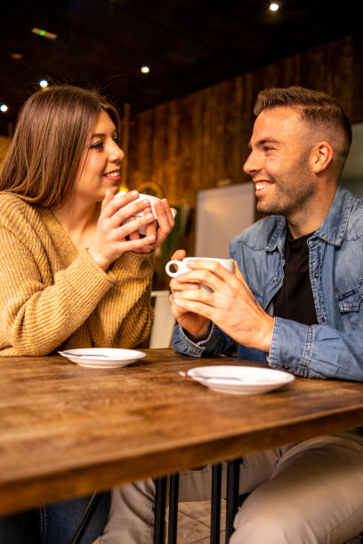 istock Happy couple talking and flirting on a coffee shop 1295059623