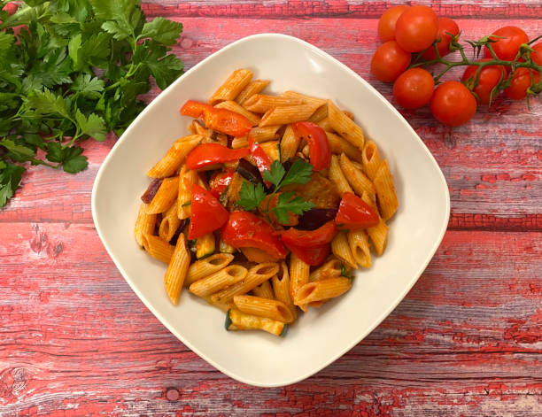istock Classic, vegetable penne pasta with red bell pepper and garden vegetables. 1295059826