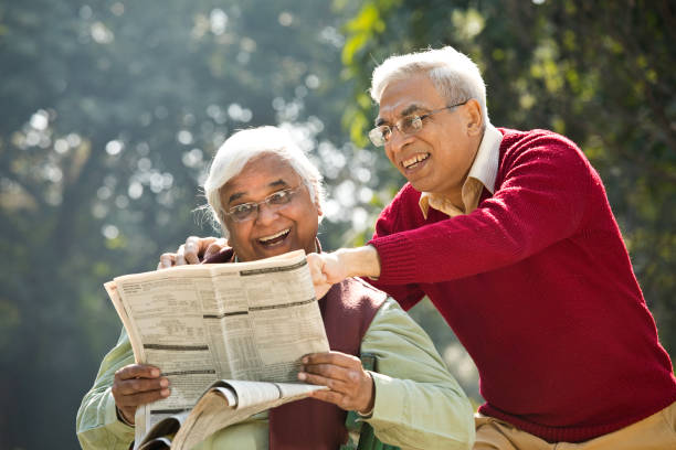 istock Two senior men having fun reading newspaper 1295060605