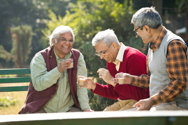 istock Senior men enjoying hot tea at park 1295060638