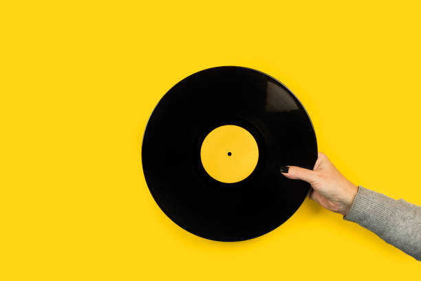 istock Woman hand holding a vinyl disc 1295062096