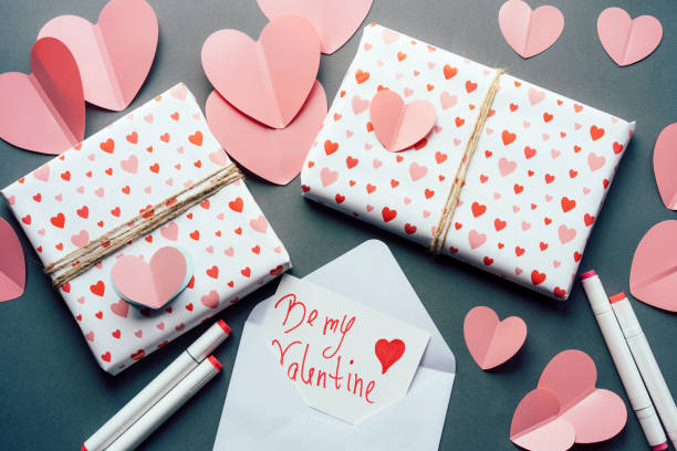 istock Top view of table with hearts and gift boxes 1295063876